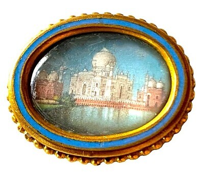 A very unusual medium oval painting under glass button!