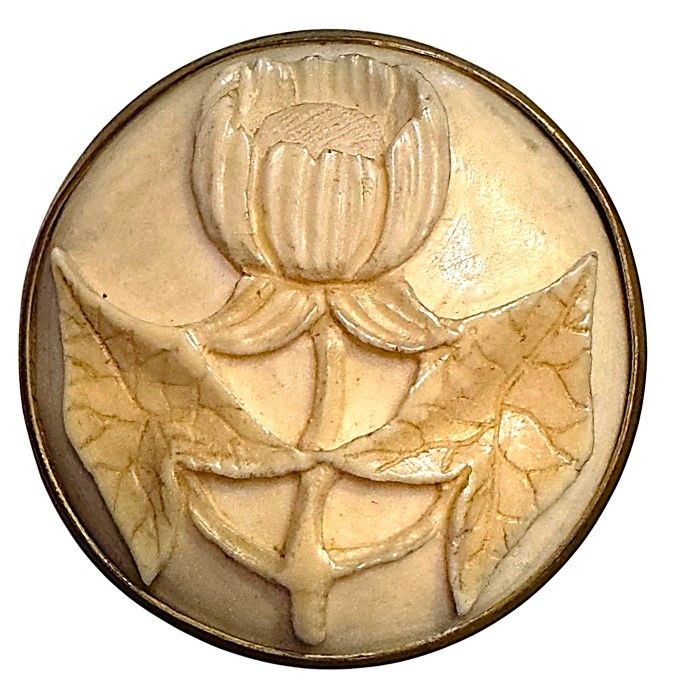 A large 19th century hand carved natural material button in metal!