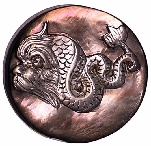 A wonderful large medium deeply carved chatoyant pearl pictorial button!