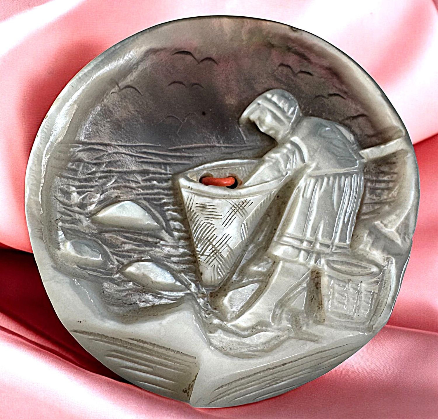 A beautifullty carved large 19th century chatoyant pearl button!