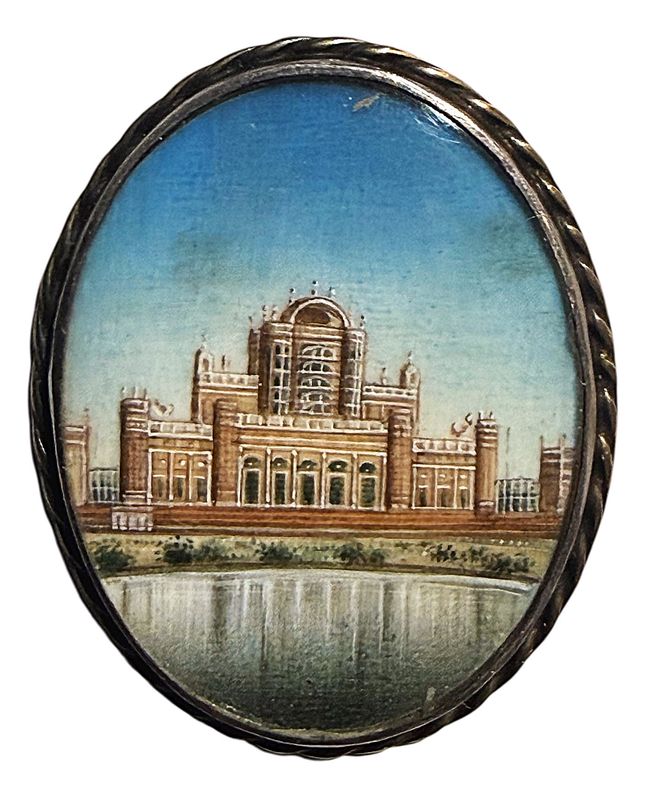 A large hand painted 19th century under glass button!