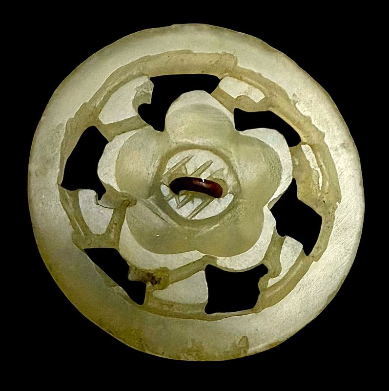 A MEDIUM JAPANESE PIERCED JADE BUTTON