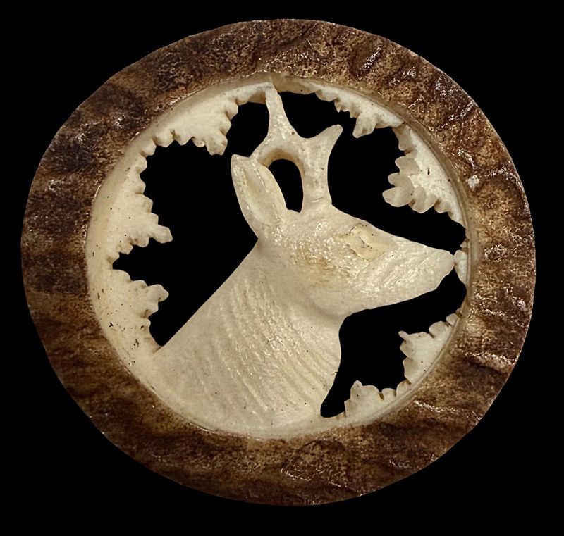 A division oen carved and pierced antler pictorial button
