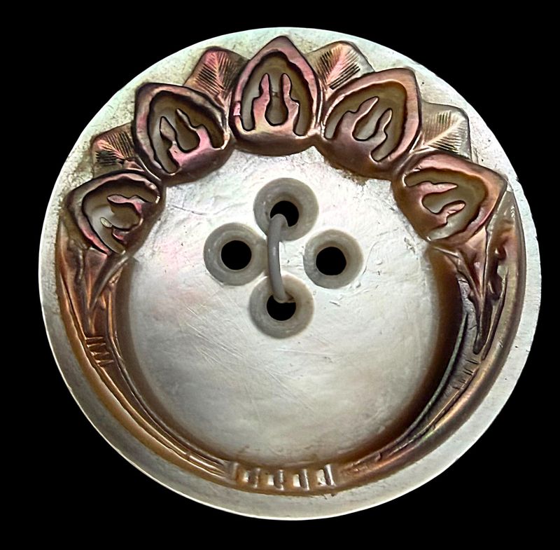 A divion one carved sew thru smokey and white pearl button