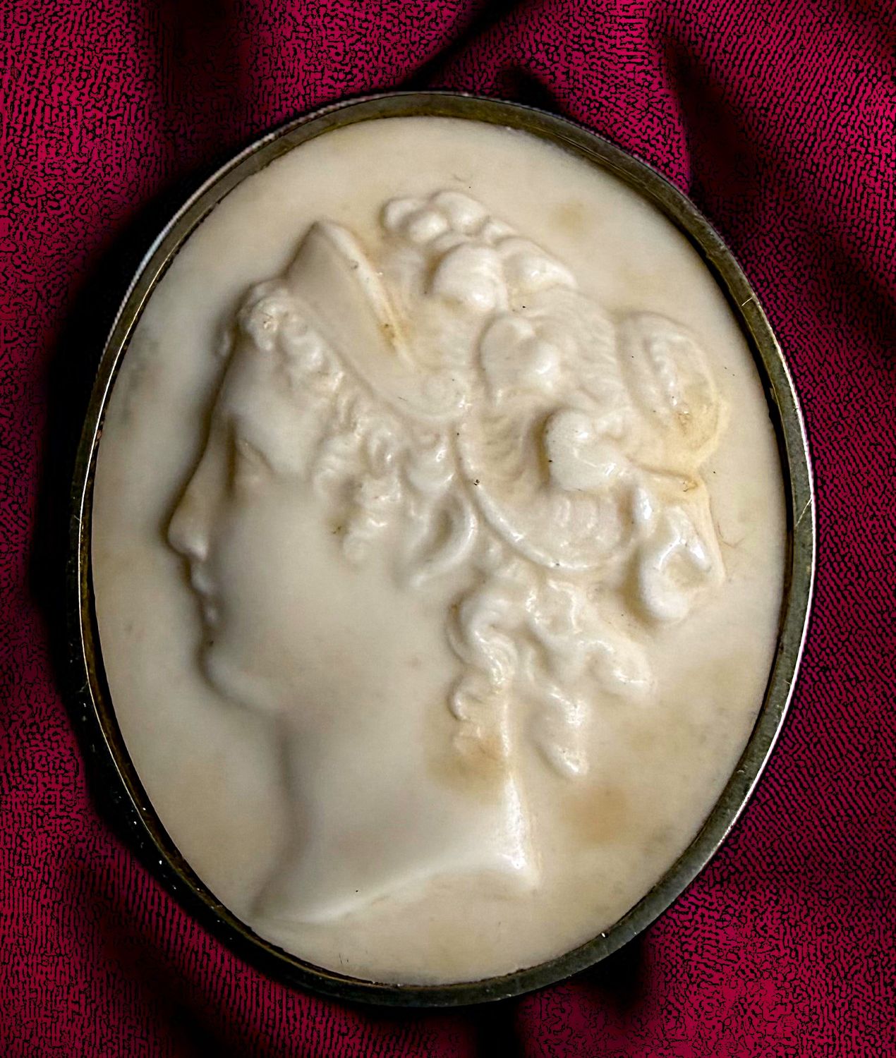 A large oval division one hand carved profile button