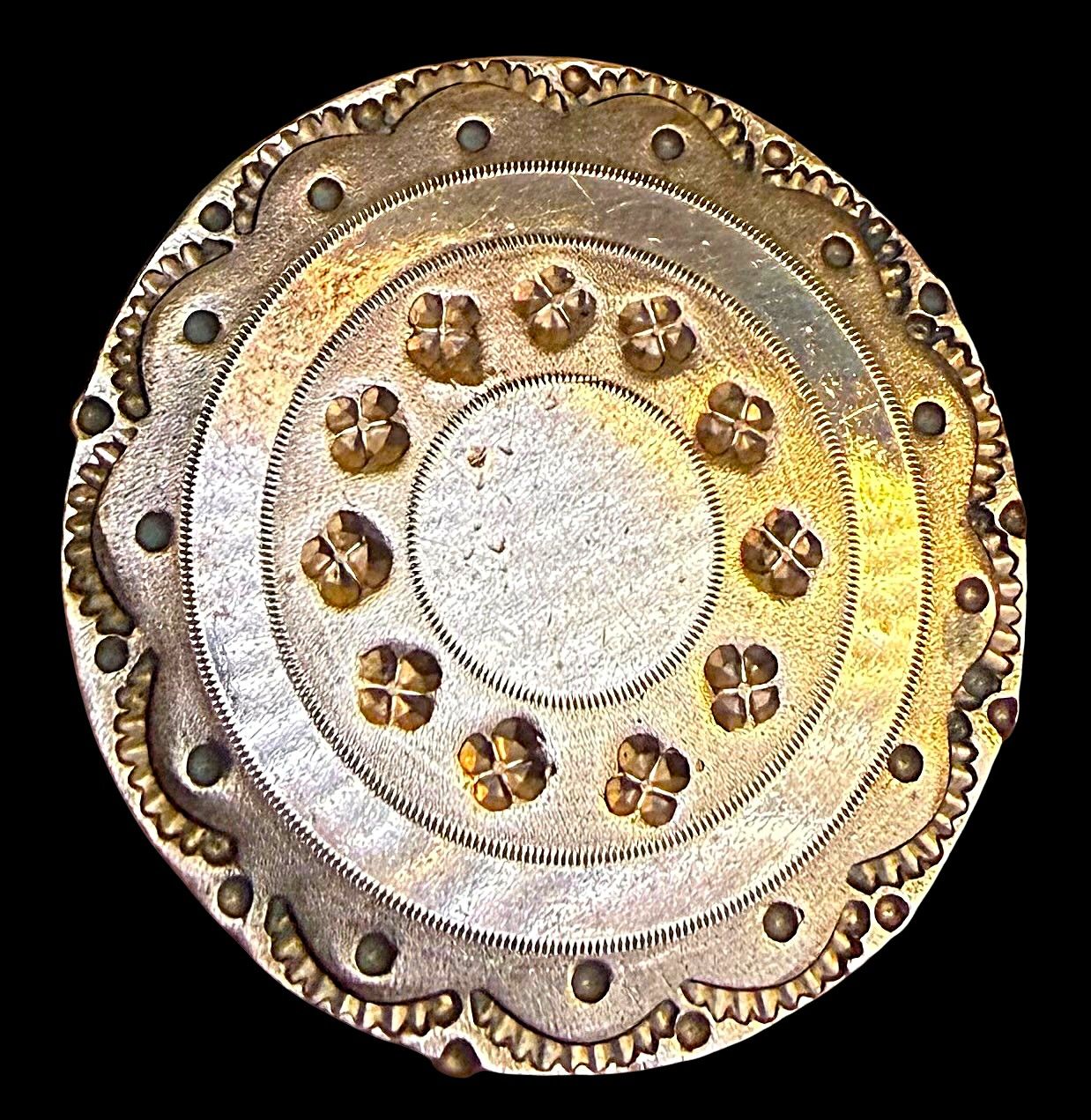 An 18th century chased and engraved copper button