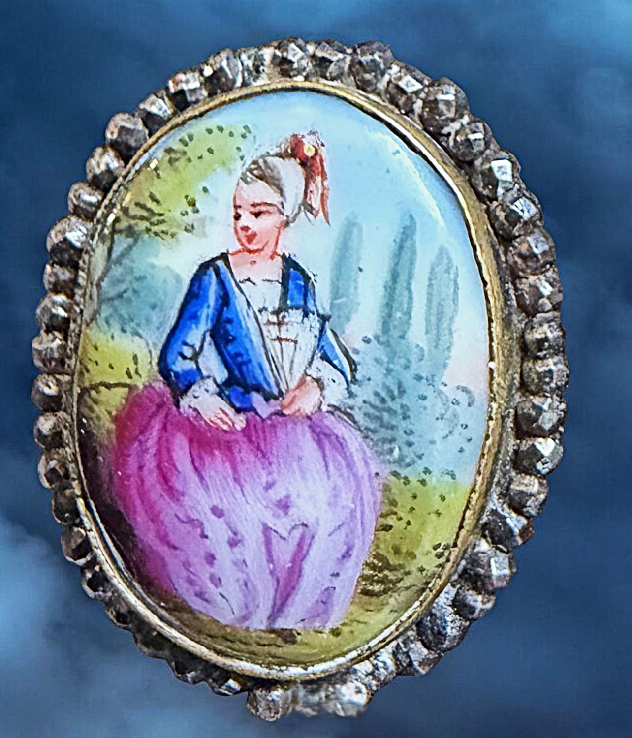 A medium oval hand painted porcelain in metal button!