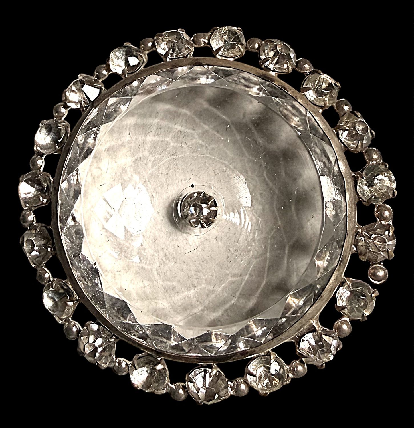 A womnderful faceted crystal clear glass button with paste border!