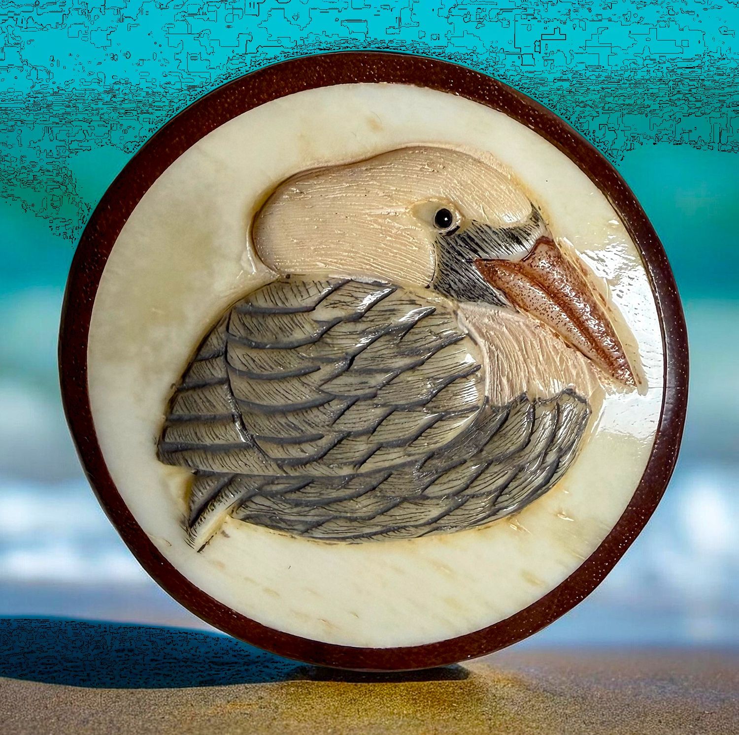 A large wood button with a Pelican.