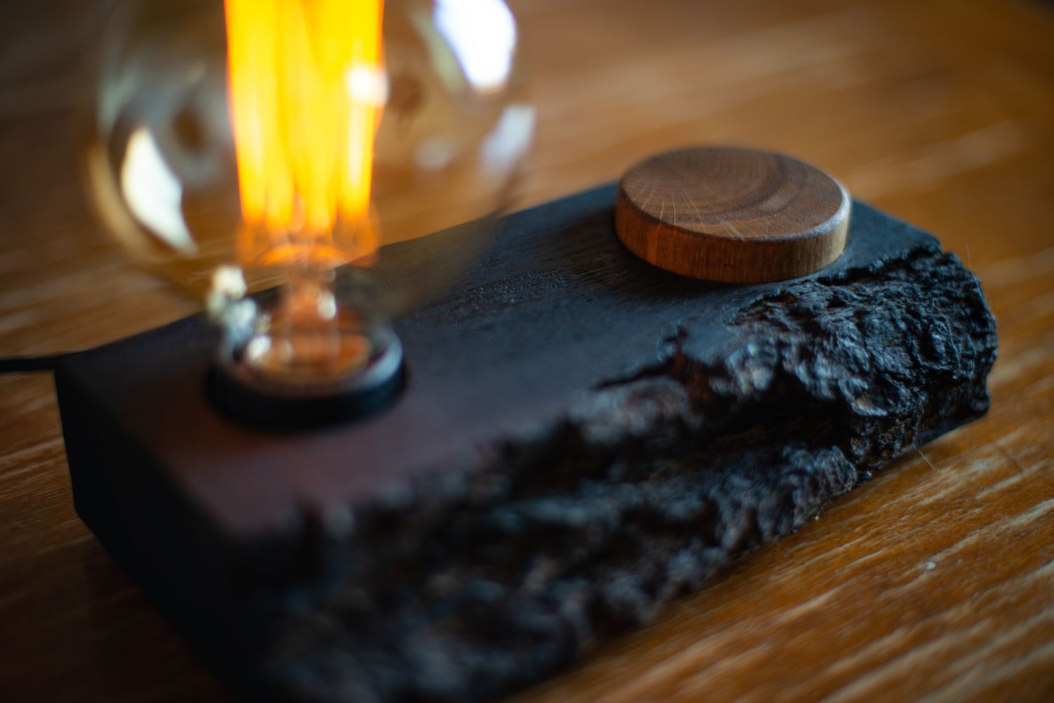 Loft-style table lamp with a natural wood base featuring rough bark texture and a round wooden knob, with an Edison lamp