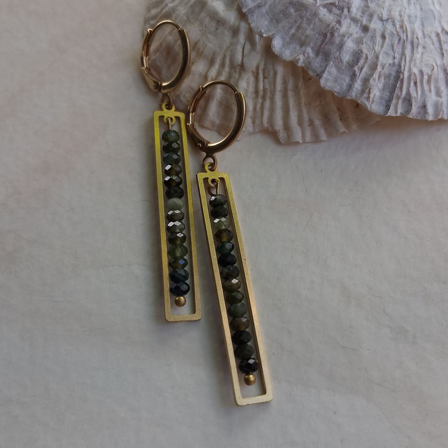 Faceted green tourmaline gemstone earrings framed in brass