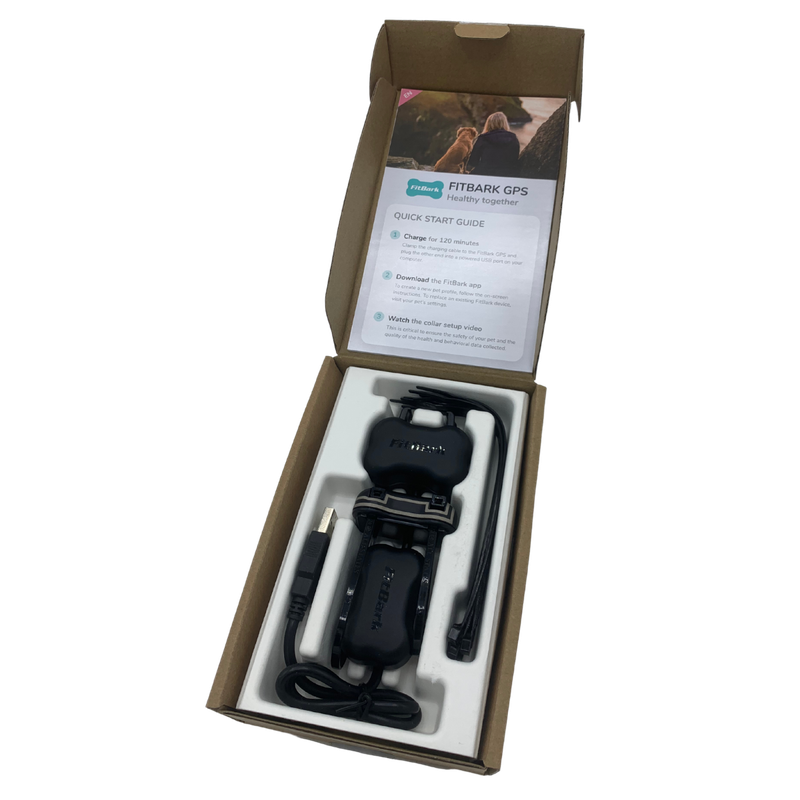 FitBark GPS 2nd Generation unboxed, showing device, collar clip, and quick start guide