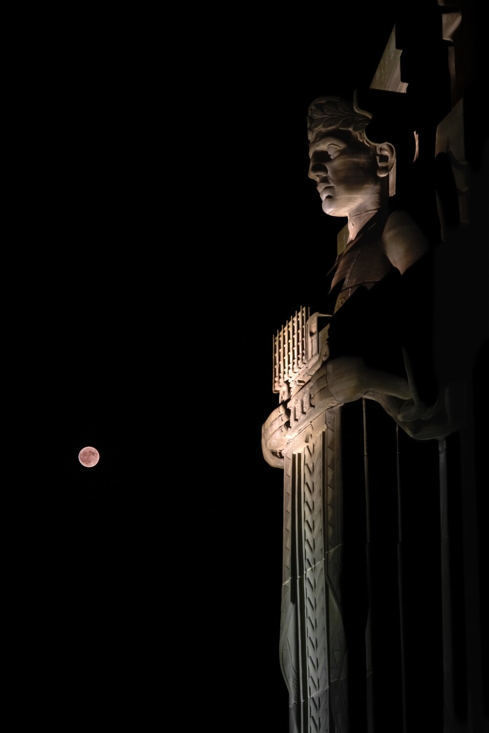 Strawberry Moon Overlooked by Stoic Guardian of Traffic