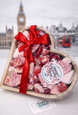 Valentine's Sweets in a wooden heart with an image of London and a red bus in the background