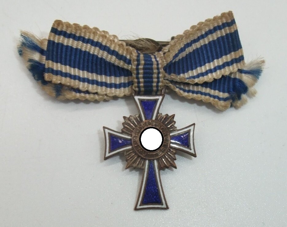 Mutterkreuz in Bronze, 3. Stufe, Miniatur, an Schleife.