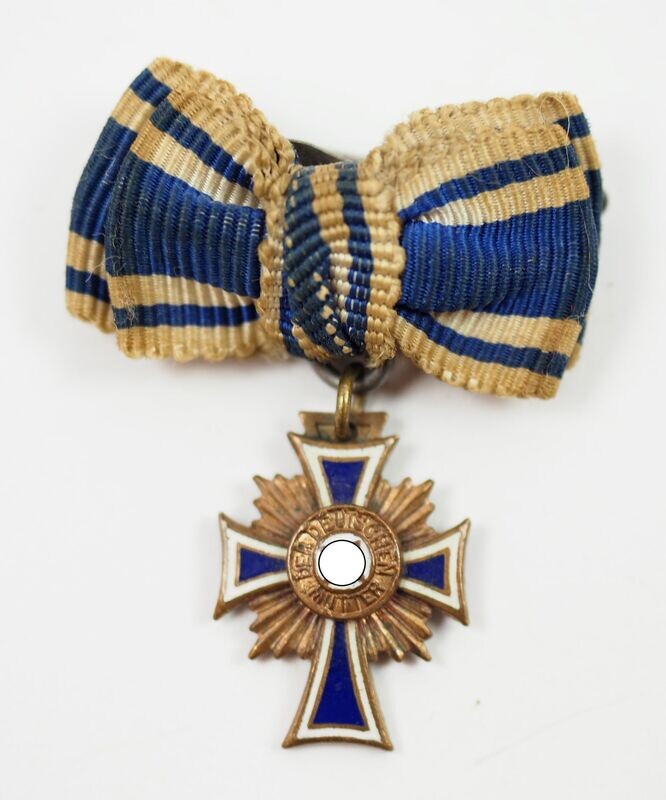 Mutterkreuz in Bronze, 3. Stufe, Miniatur, an Schleife.