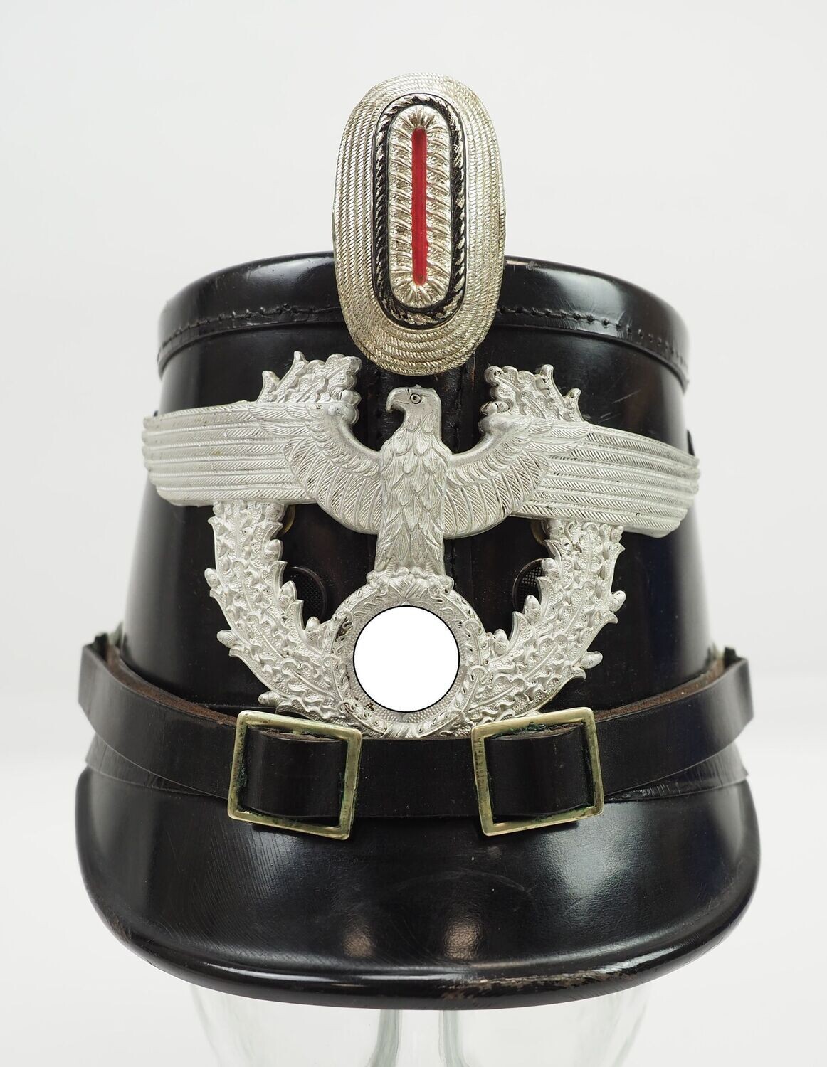3. Reich: Polizei Tschako für Mannschaften der Schutzpolizei, Hersteller und Trägeretikett Becker, Gewindestangen des Emblems ersetzt und Doppellöcher im Tschako, Pflaume mit Hersteller Assmann 1934.