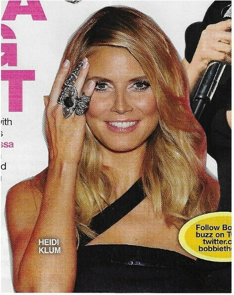 Klum, Heidi / Black Dress, Holding Up Ring | Magazine Photo | March 2010