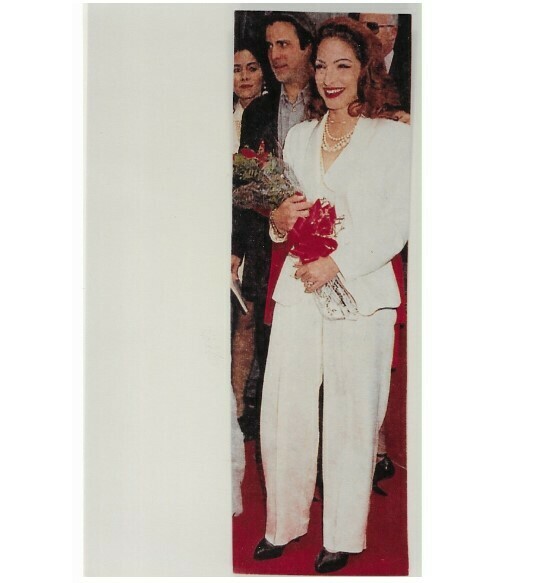 Estefan, Gloria / Dressed in White, Holding Red Flowers | Photo Print