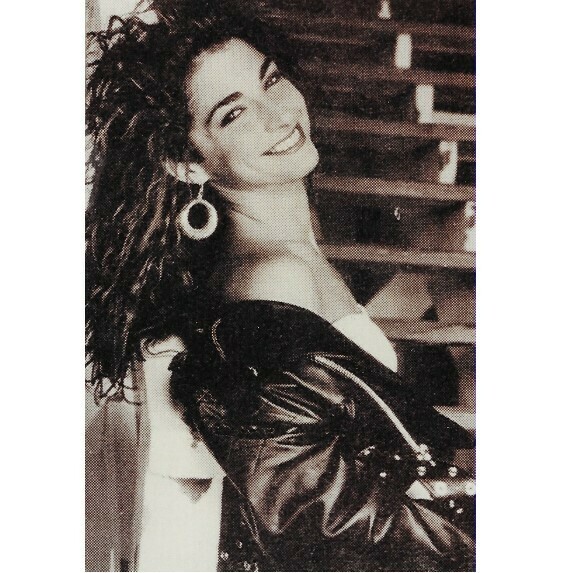 Estefan, Gloria / Smiling, In Leather Jacket, Leaning Back, Steps in Background | Photo Print