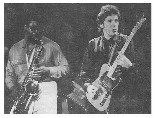 Springsteen, Bruce / On Stage, Playing Guitar, Looking to His Left | Magazine Photo | 1970s | with Clarence Clemons | Large Version