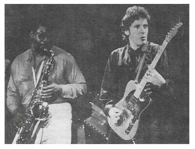 Springsteen, Bruce / On Stage, Playing Guitar, Looking to His Left | Magazine Photo | 1970s | with Clarence Clemons | Large Version