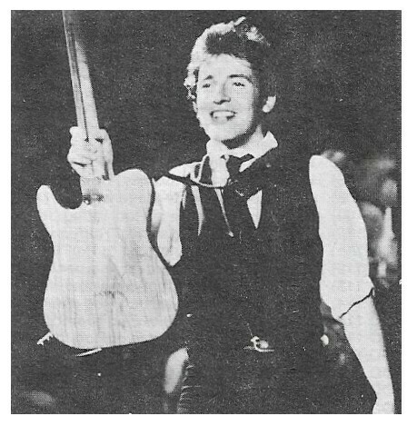 Springsteen, Bruce / On Stage, Smiling, Holding Guitar Up | Magazine Photo | 1970s | Large Version