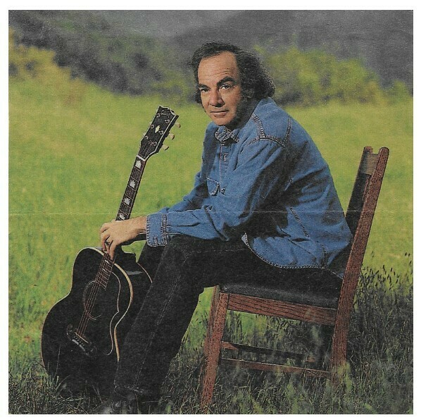 Diamond, Neil / Outdoors-Wooden Chair-Guitar | Magazine Photo | June 1993