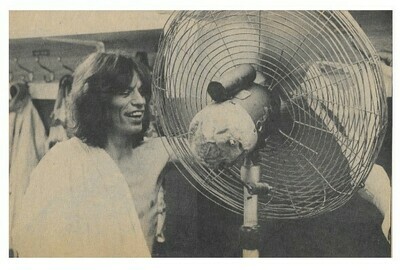 Jagger, Mick / Holding Women&#39;s Undergarment in Front of Electric Fan | Magazine Photo | September 1973