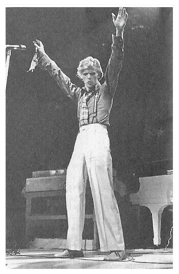 Bowie, David / On Stage-Baggy Pants-Arms Reaching Up | Magazine Photo