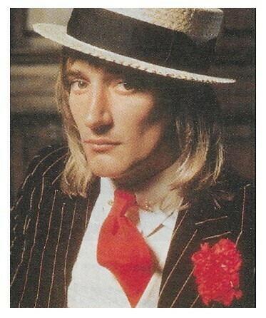 Stewart, Rod / Wearing Boater Hat-Striped Suit-Red Tie | Magazine Photo | 1976