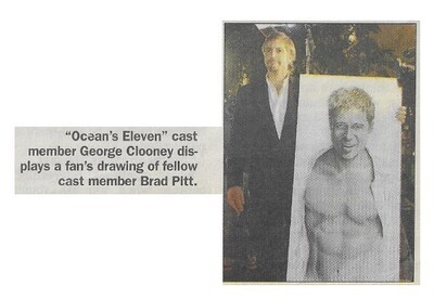 Clooney, George / Displaying Fan's Drawing of Brad Pitt / 2002