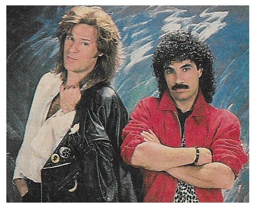 Hall + Oates / Both Standing - John in Red Jacket - Blue Background | Magazine Photo | 1988