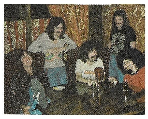 Boston / Group Gathered Around Table-Tom Laughing | Magazine Photo | 1977