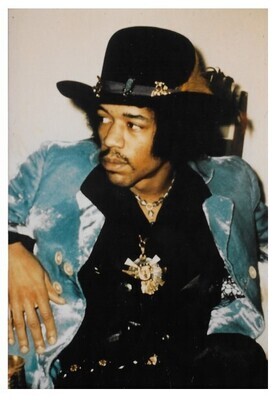 Hendrix, Jimi / Sitting-Black Hat-Blue Jacket-Looking to His Right