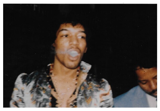 Hendrix, Jimi / Standing-Exhaling Smoke-Dark Background