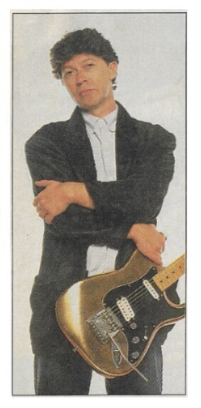 Robertson, Robbie / 1988: Standing-Gold Guitar-White Background