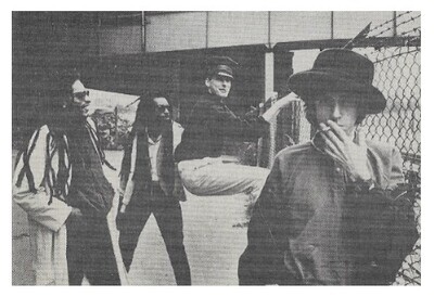 Big Audio Dynamite / Group Near Chain Link Fence / 1984