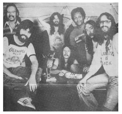 Doobie Brothers, The / Group Photo - Michael Wearing Olympia Beer Shirt / 1976