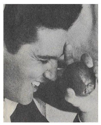 Presley, Elvis / Closeup-Eyes Closed-Holding Apple