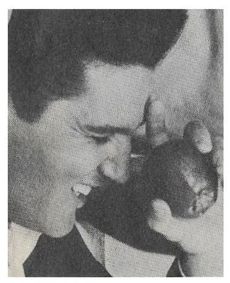 Presley, Elvis / Closeup-Eyes Closed-Holding Apple
