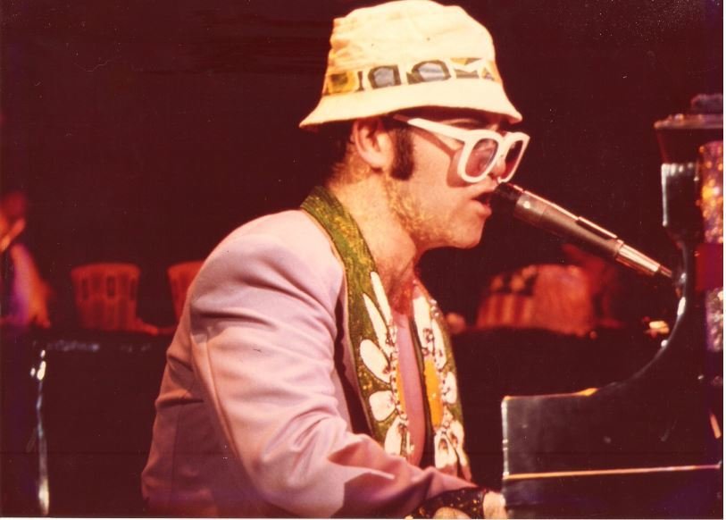 John, Elton / At Piano, Profile, White Glasses, Hat, Mostly Purple Jacket | Photo Print (1976)