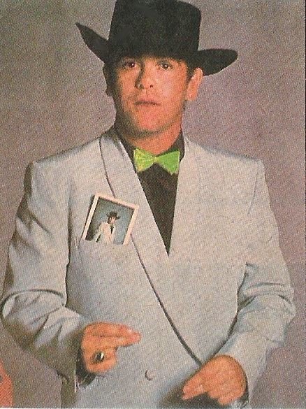 John, Elton / Light Blue Jacket, Black Hat, Green Bowtie - Jump Up! Era | Magazine Photo (1982)
