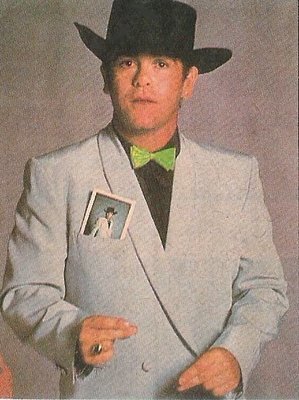 John, Elton / Light Blue Jacket, Black Hat, Green Bowtie - Jump Up! Era | Magazine Photo (1982)