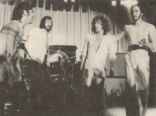Who, The / Group On Stage - Pete On Right Holding Drink | Magazine Photo (1973)