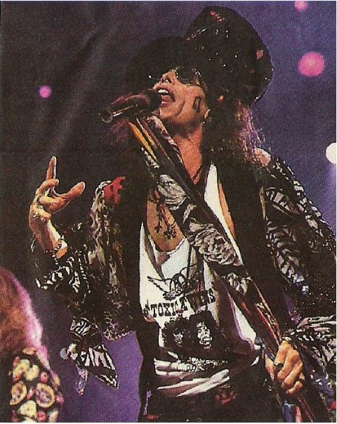 Aerosmith / Steven On Stage, Large Hat, Purple Background | Magazine Photo (1993)