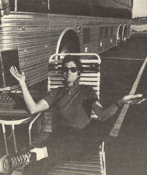 Lewis, Huey (and The News) / Huey Sitting in Lawnchair Near Bus | Magazine Photo (1984)