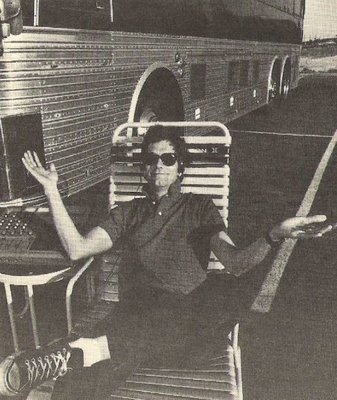 Lewis, Huey (and The News) / Huey Sitting in Lawnchair Near Bus | Magazine Photo (1984)