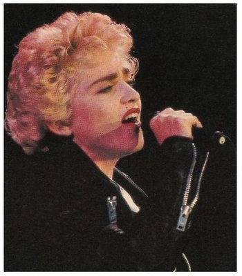 Madonna / On Stage - Black Zippered Jacket - Holding Mic. | Magazine Photo | 1987