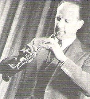 Goossens, Leon / On Stage - Playing Oboe - Curtain in Background | Magazine Photo | Undated